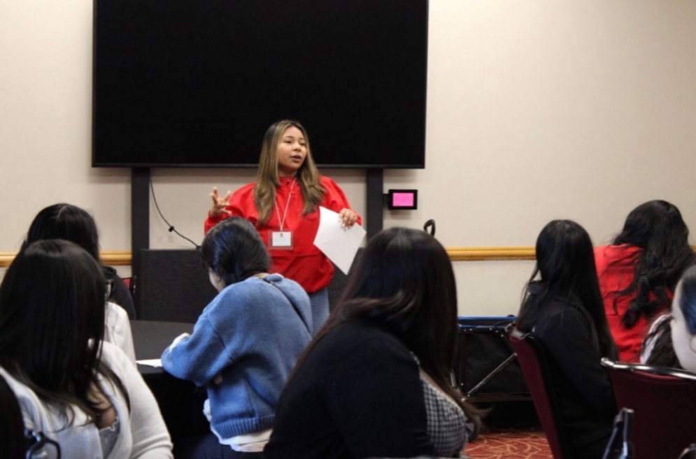 Paola speaking to an attentive audience