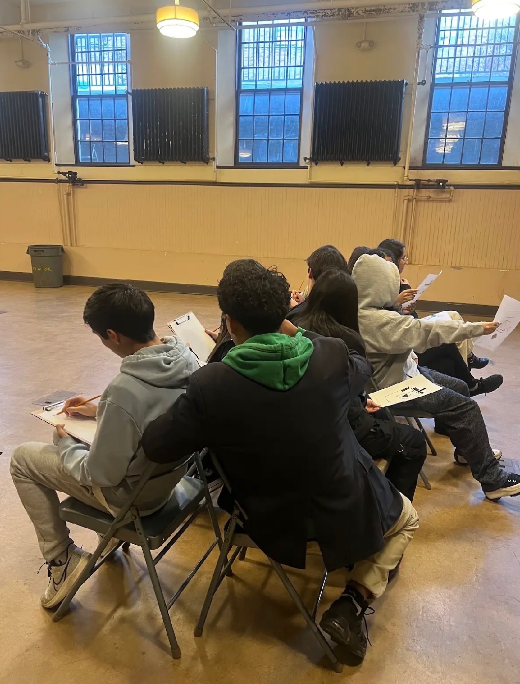 Students sketching in a workshop space